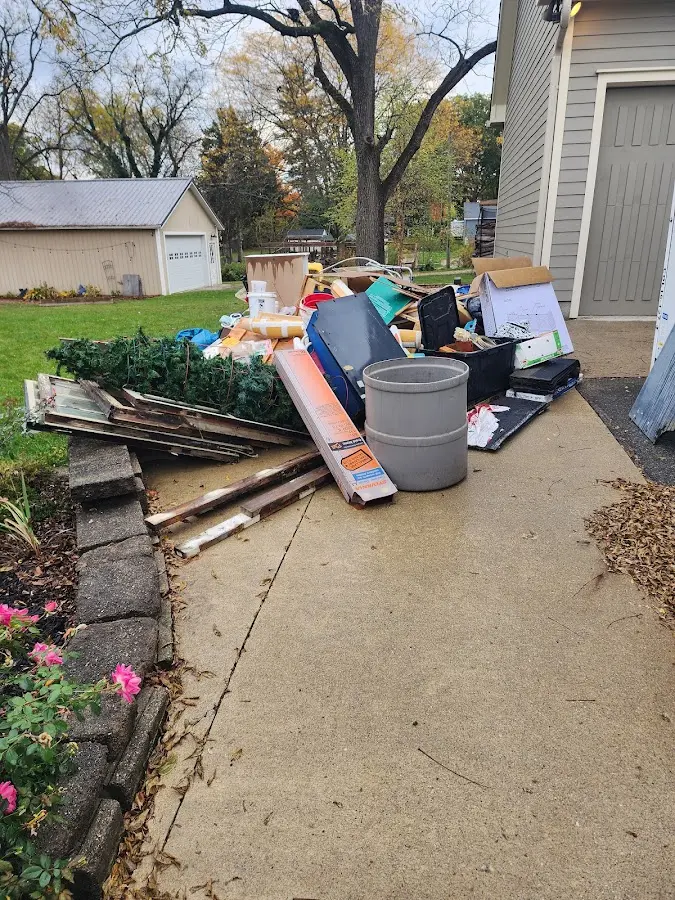 Dumpster being loaded with debris for Estate Cleanout Dumpster Rental in Quincy